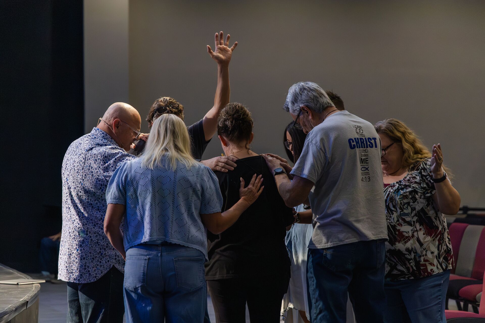 Church members laying hands on and praying for one another at Pathway Church